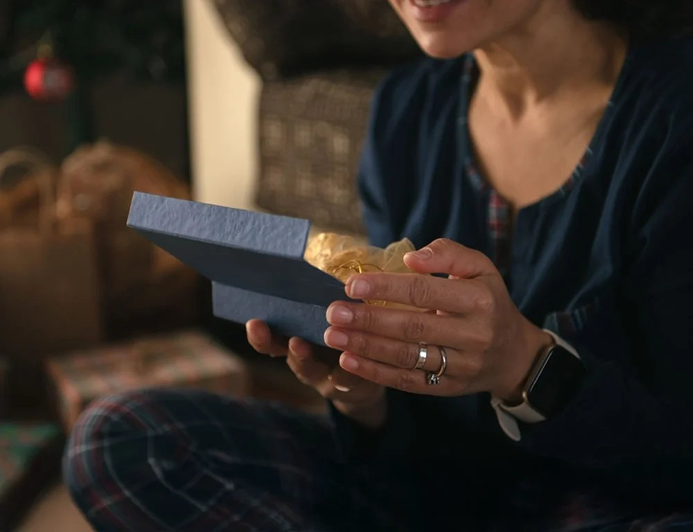 woman opening a jewellery box with premium packaging presentation